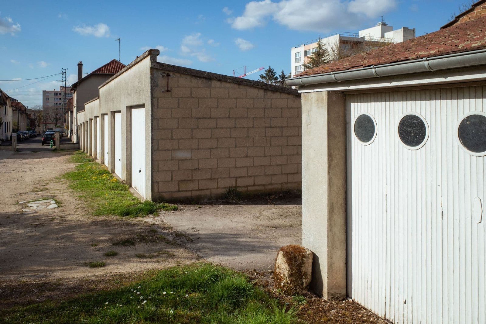 A row of lock-up garages with pitched roofs