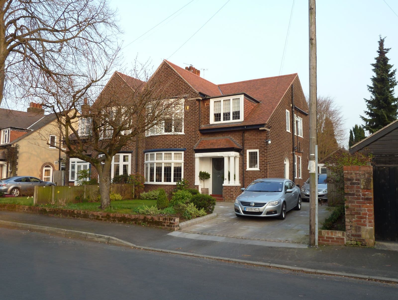 Interwar semi-detached houses with tiled roofs on Grange Avenue, Hale