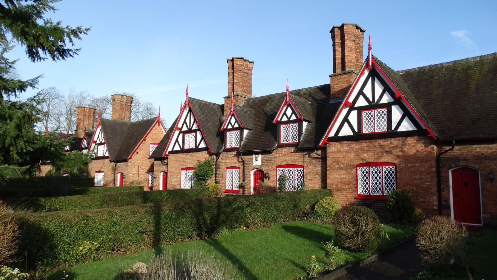 Timber-framed almshouses with tall chimneys on Welsh Row, Nantwich