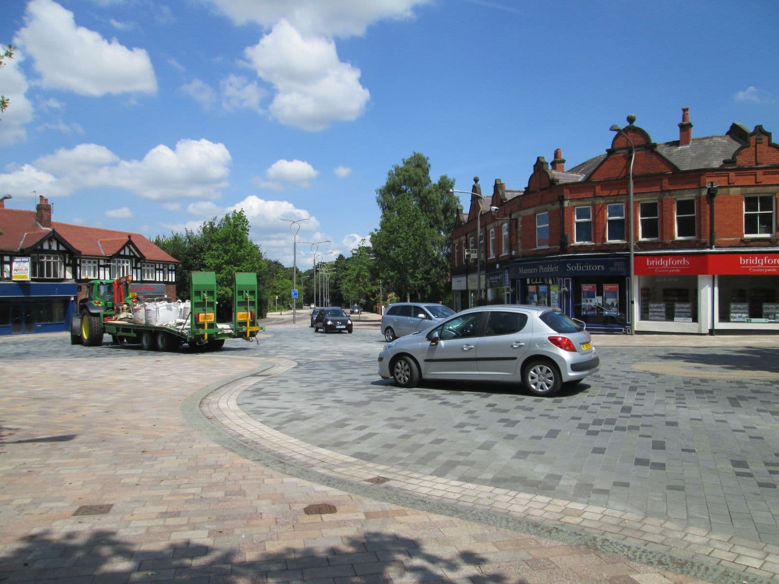 Brick shops with slate roofs in Poynton village centre on the A523