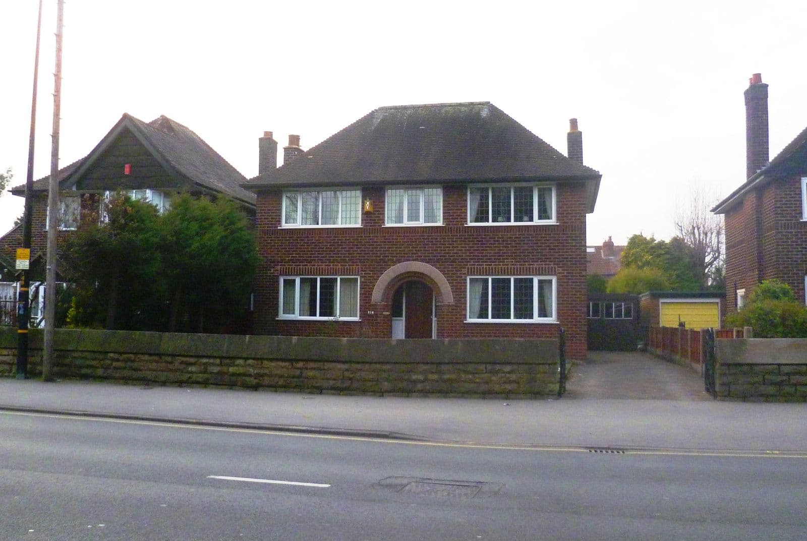 A 1930s brick detached house with a hipped tiled roof on Washway Road, Sale