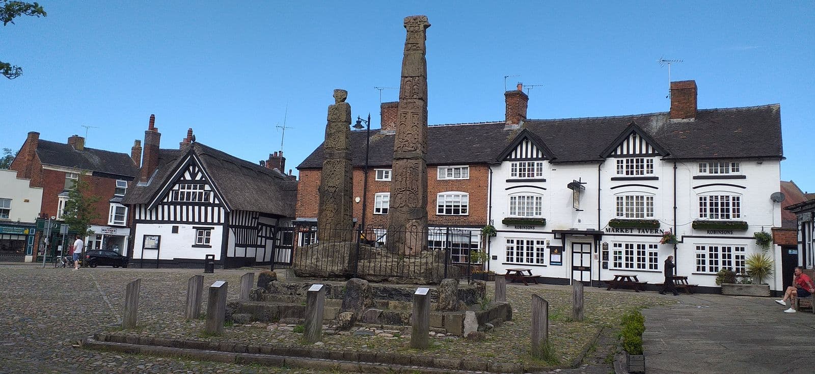 The Saxon crosses in Sandbach market square with timber-framed buildings behind