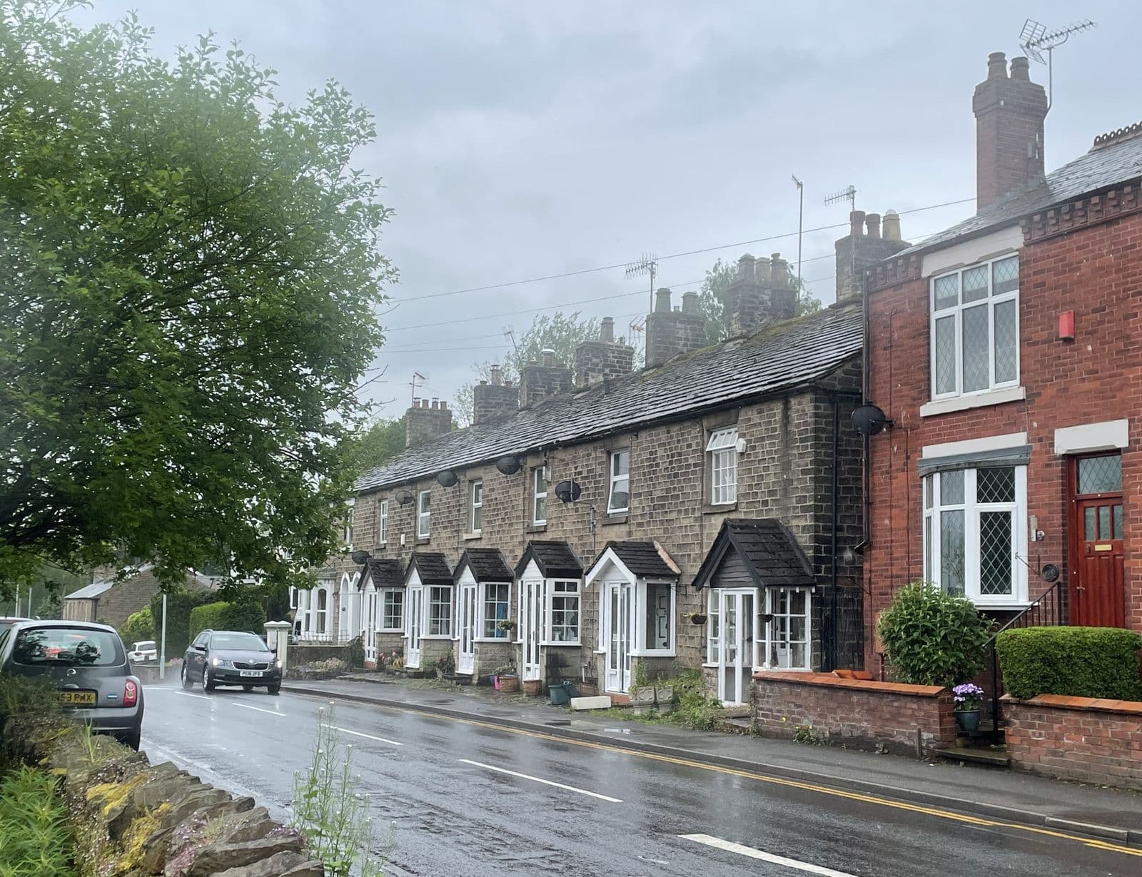 Brick and stone terraced houses with slate roofs on Strines Road, Stockport